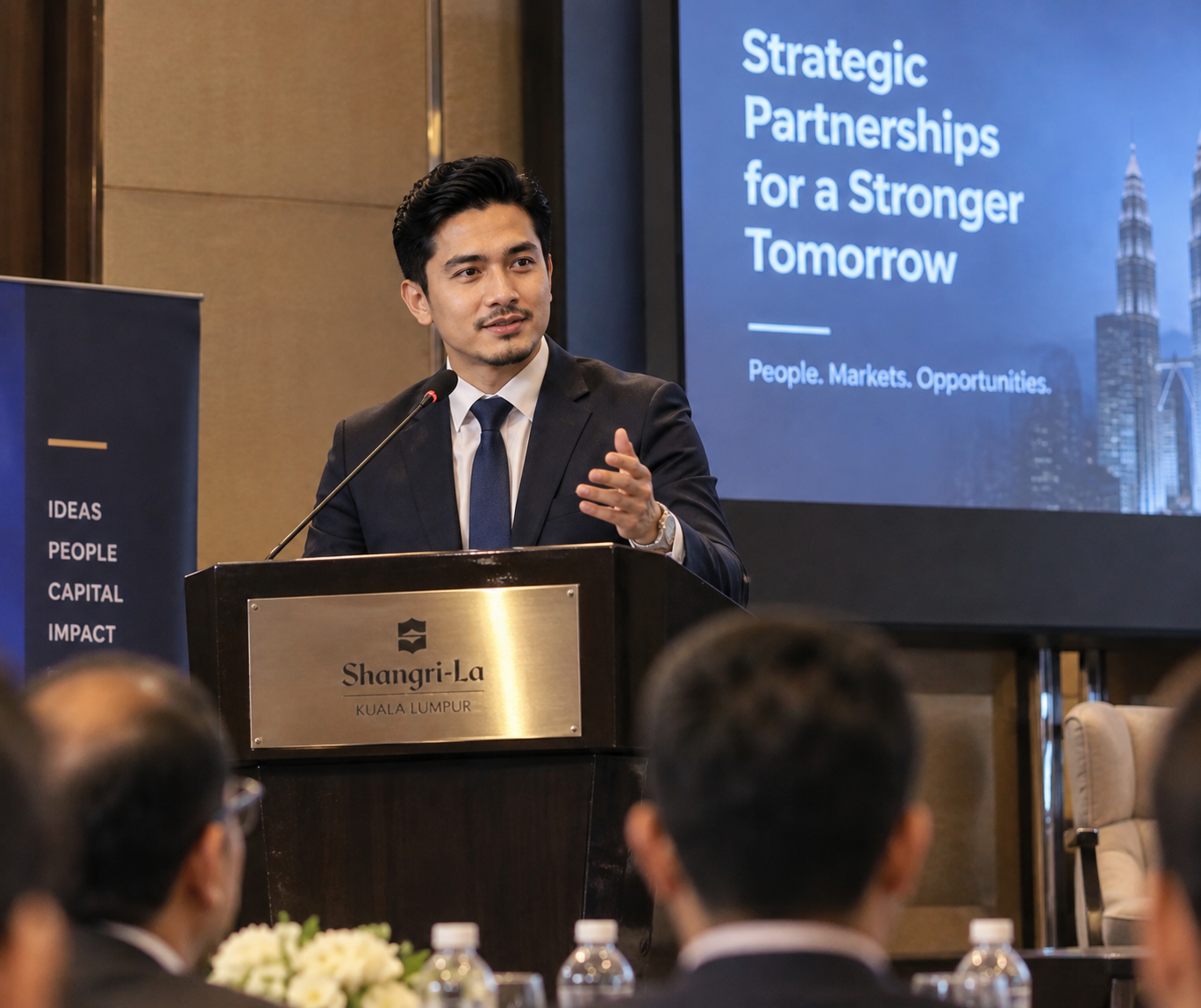Muhammad Aiman Bin Rahman speaking at a business event in Kuala Lumpur